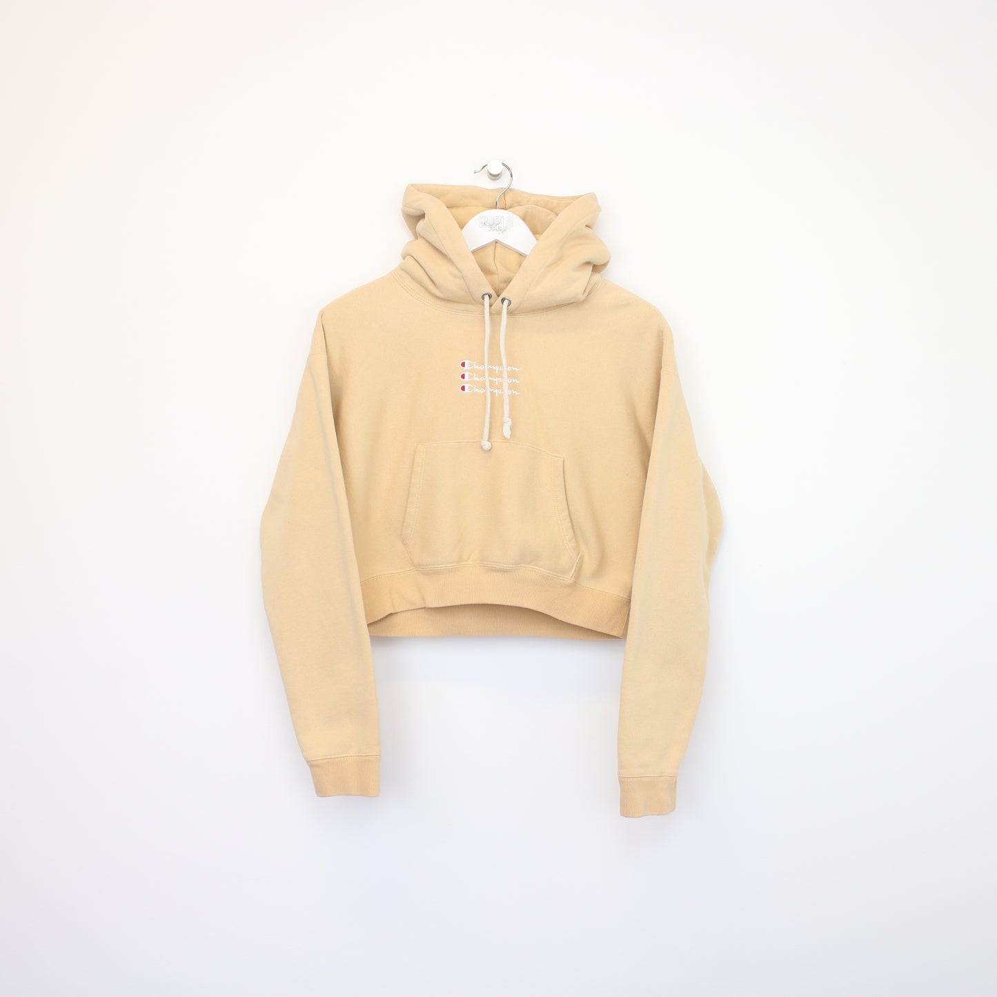 Vintage women's Champion cropped hoodie in beige. Best fits M