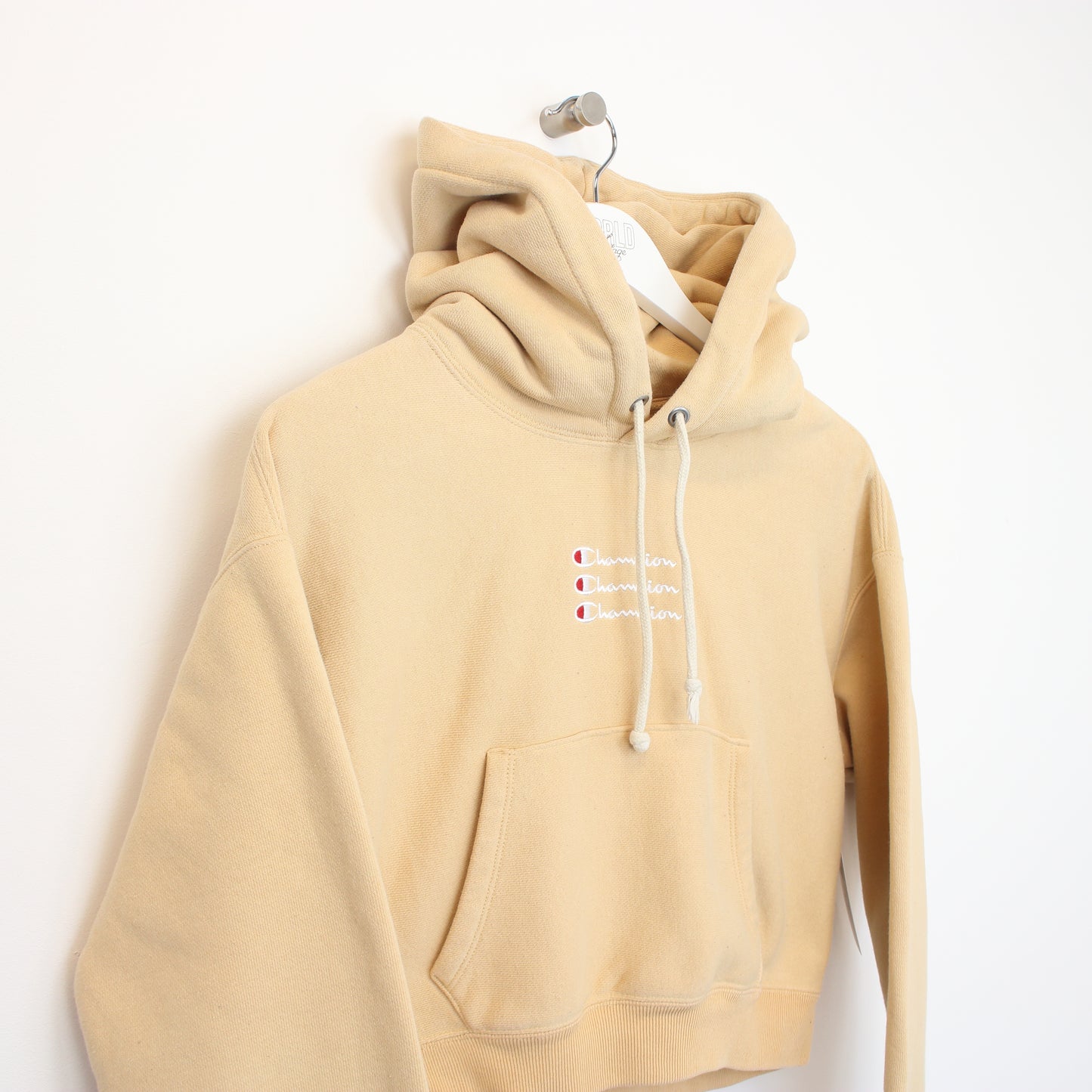 Vintage women's Champion cropped hoodie in beige. Best fits M