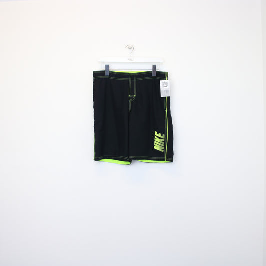 Vintage Nike shorts in black and green. Best fits L