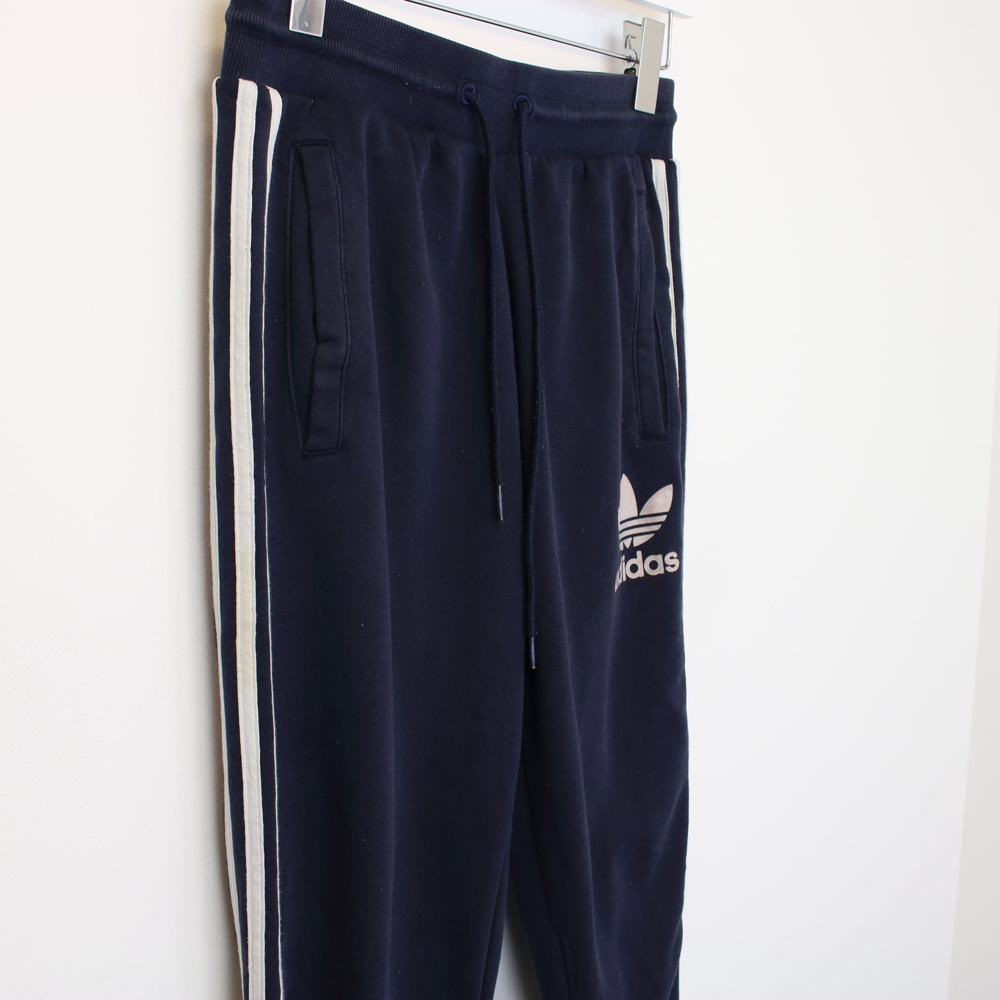 Vintage Adidas joggers in navy blue and white. Best fits XS