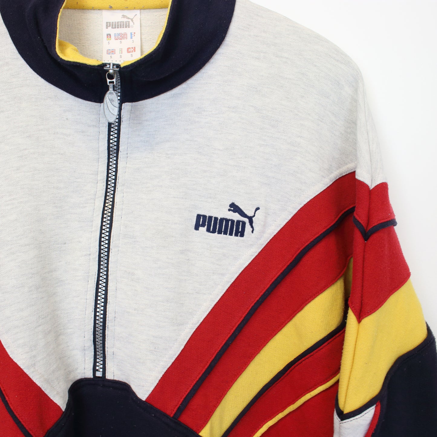 Vintage Puma sweatshirt in grey, red, yellow and blue. Best fits S