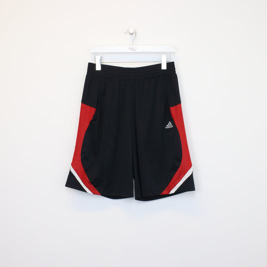 Vintage Adidas shorts in red and black. Best fits M