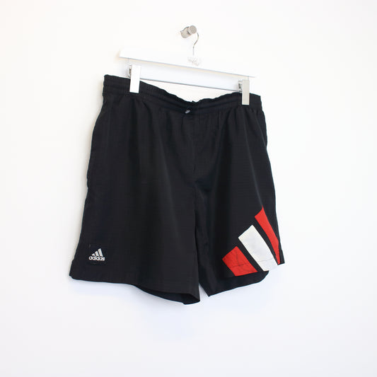 Vintage Adidas shorts in black, white, and red. Best fits XL