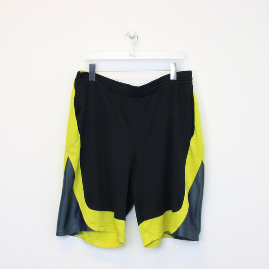 Vintage Adidas shorts in black and yellow. Best fits L