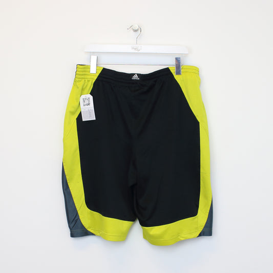 Vintage Adidas shorts in black and yellow. Best fits L