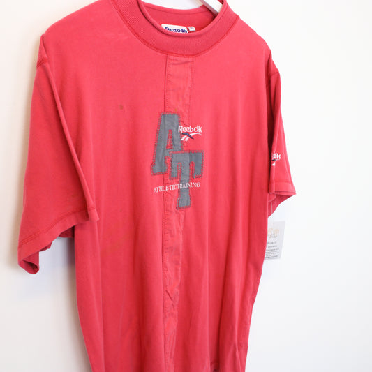 Vintage Reebok t-shirt in red. Best fits L
