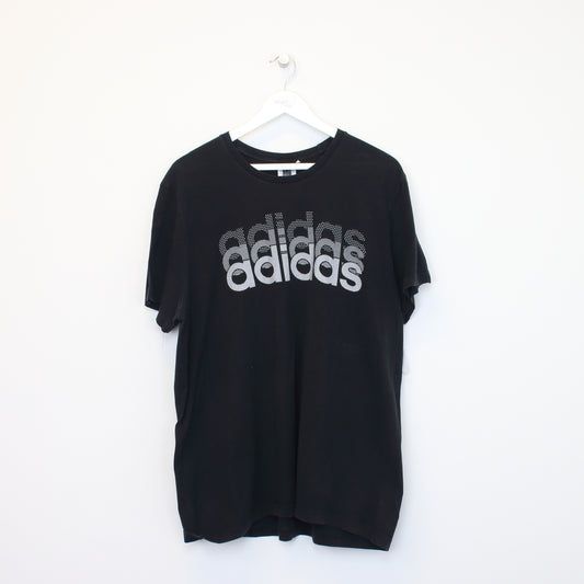 Vintage Adidas spell out T-Shirt in black. Best fits XL