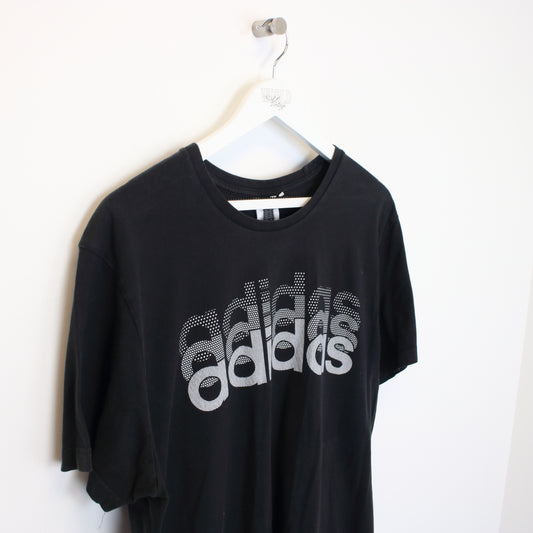 Vintage Adidas spell out T-Shirt in black. Best fits XL