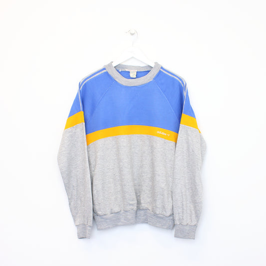 Vintage Adidas sweatshirt in grey, blue, and orange. Best fits M