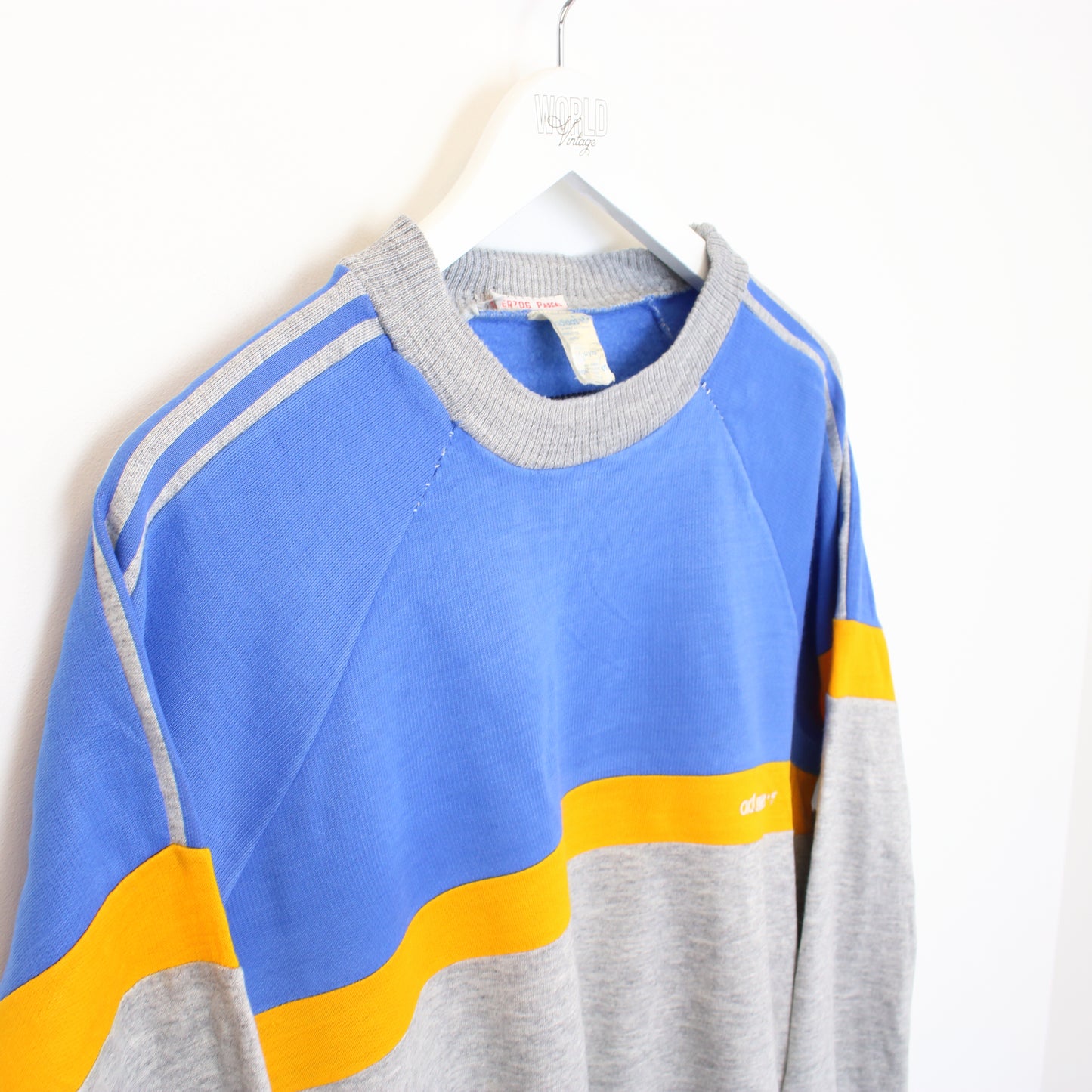 Vintage Adidas sweatshirt in grey, blue, and orange. Best fits M