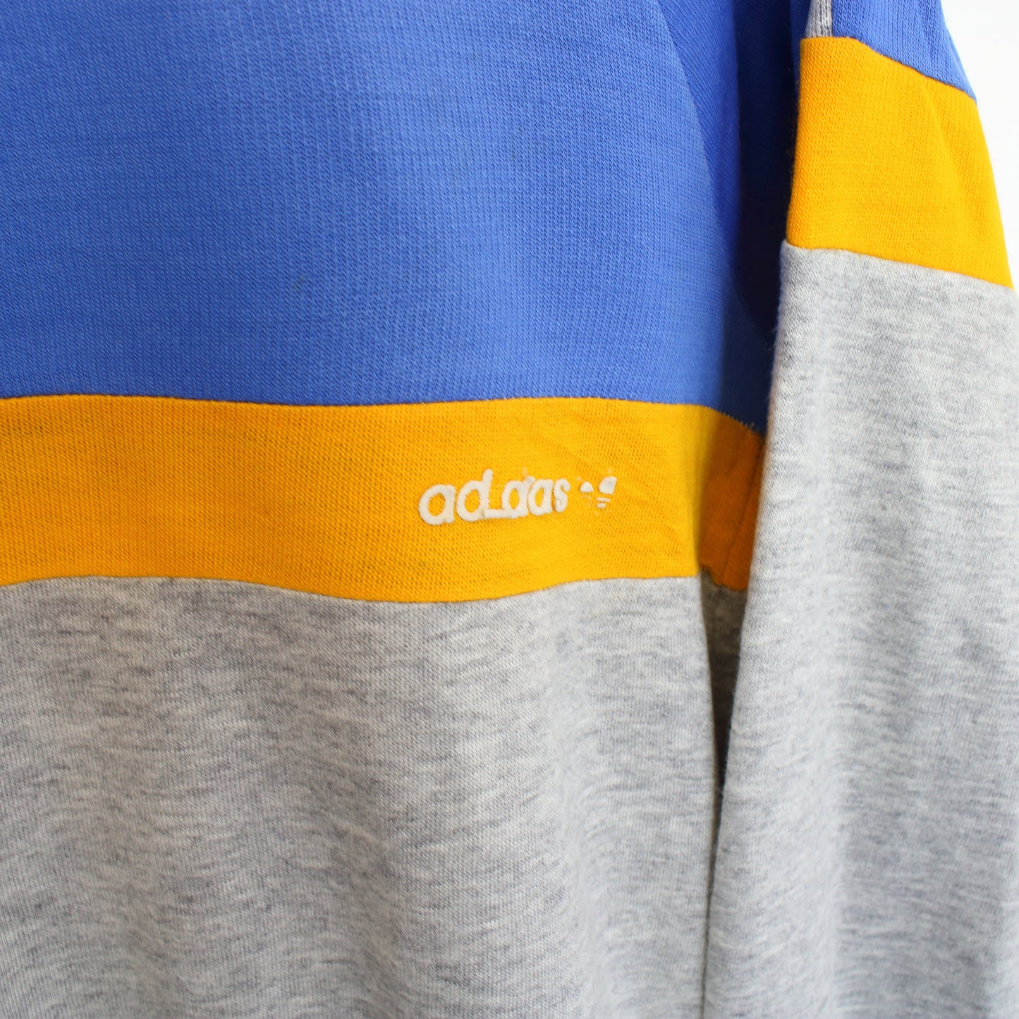 Vintage Adidas sweatshirt in grey, blue, and orange. Best fits M