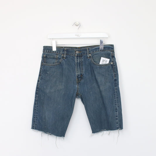 Vintage Levi's denim cut off shorts in blue. Best fits W32"