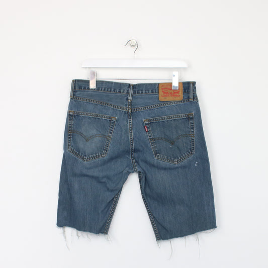 Vintage Levi's denim cut off shorts in blue. Best fits W32"