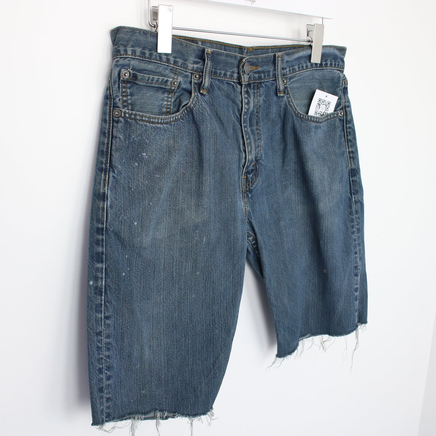 Vintage Levi's denim cut off shorts in blue. Best fits W32"