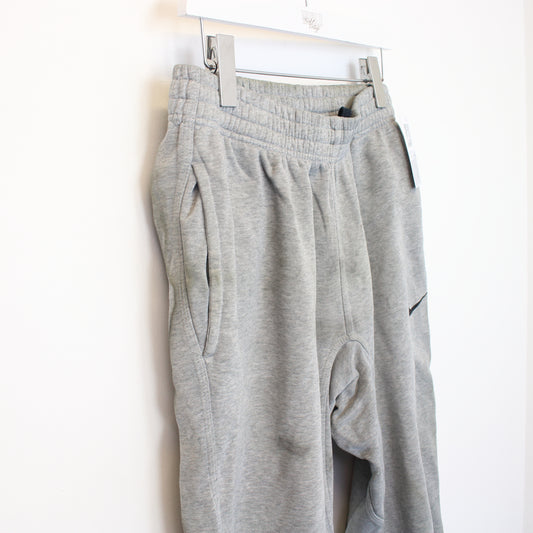 Vintage Nike joggers in grey. Best fits L