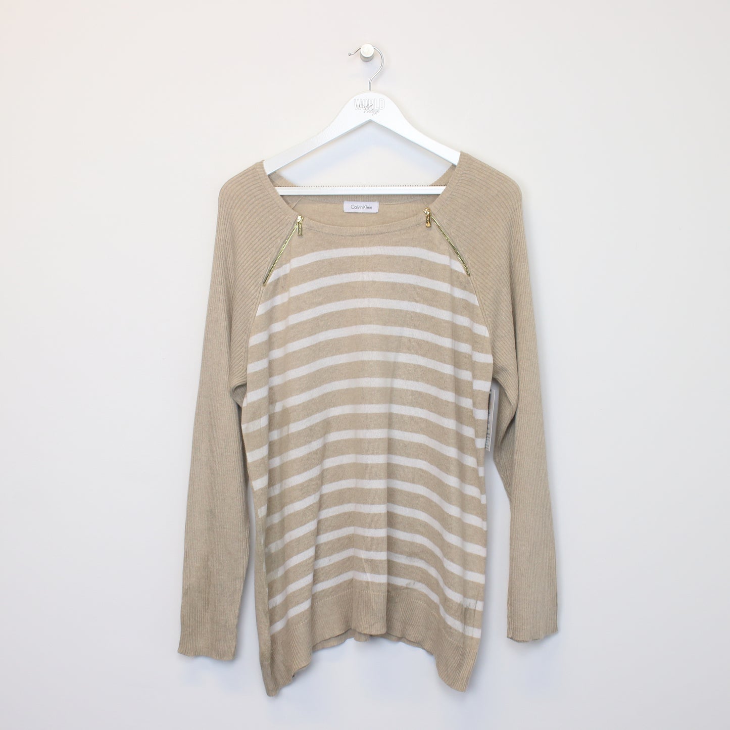 Vintage women's Calvi Klein knitted sweatshirt in beige. Best fits M