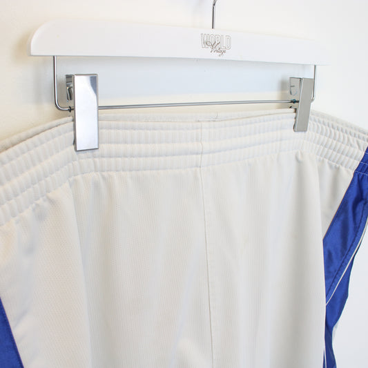 Vintage Nike shorts in white, blue, and yellow. Best fits XXL