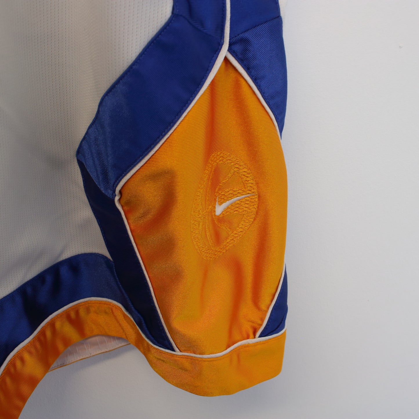 Vintage Nike shorts in white, blue, and yellow. Best fits XXL