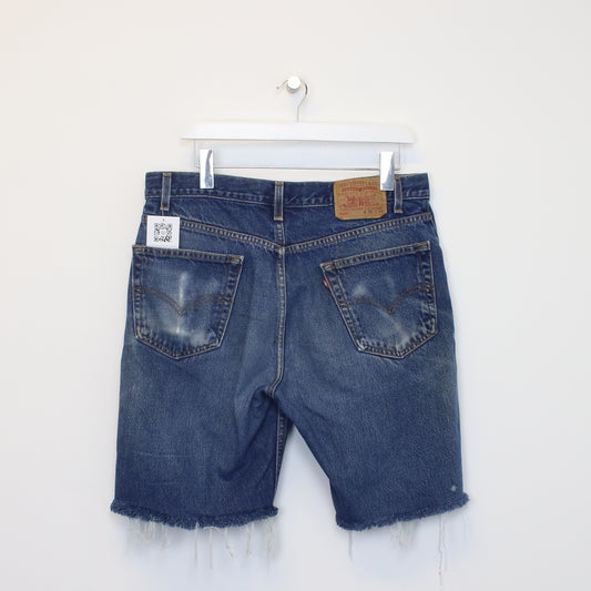 Vintage Levi's denim cut off shorts in blue. Best fits W34