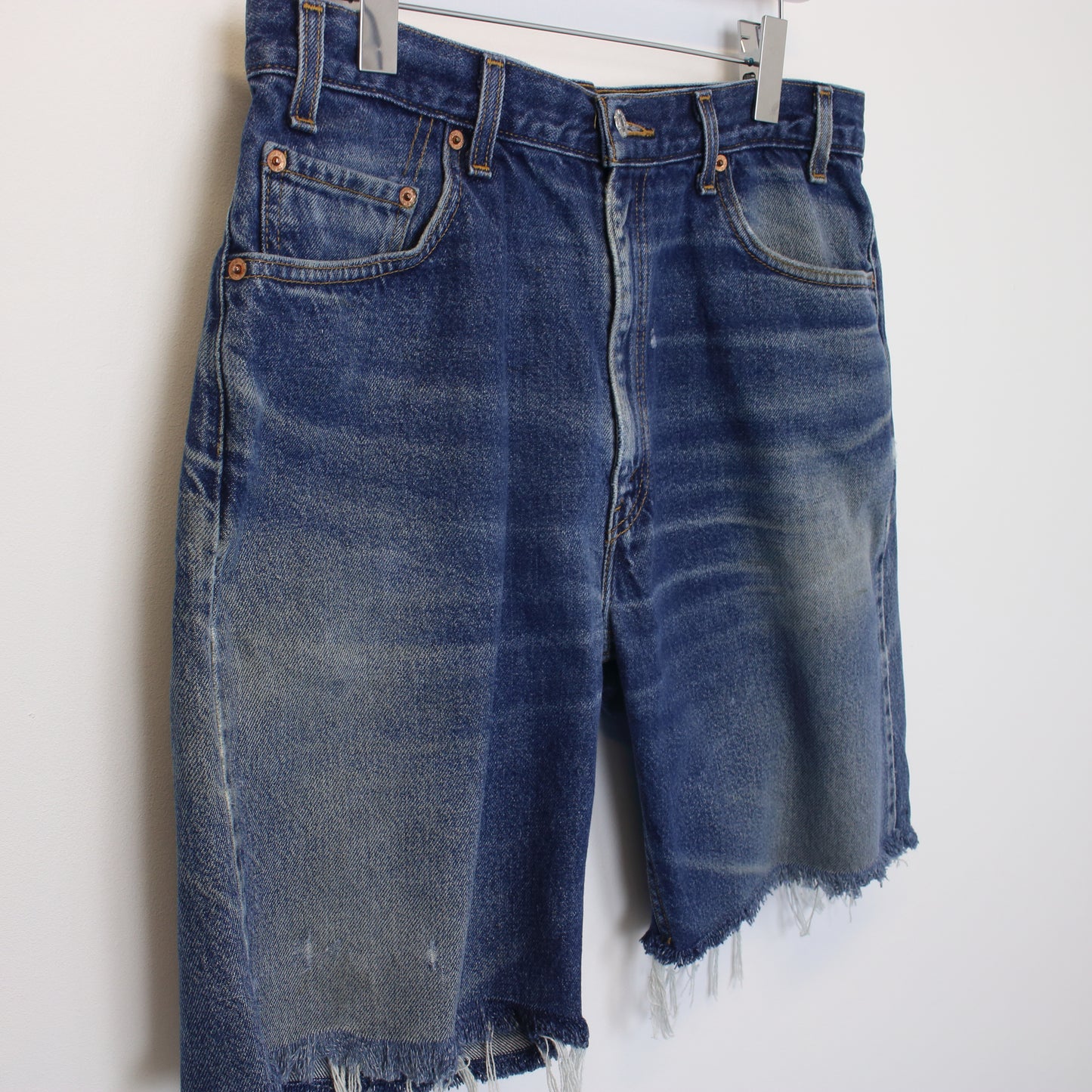 Vintage Levi's denim cut off shorts in blue. Best fits W34