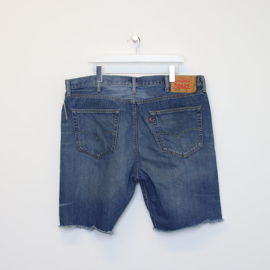 Vintage Levi's denim cut off shorts in blue. Best fits W40