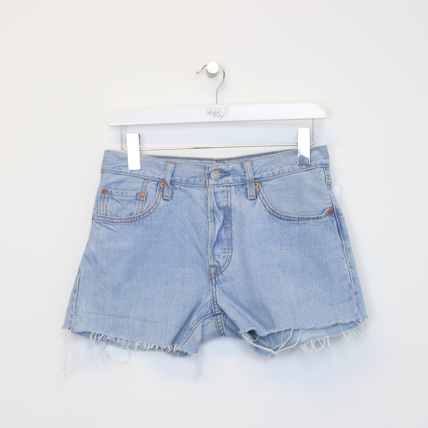 Vintage Women's Levi's denim cut off shorts in blue. Best fits W29