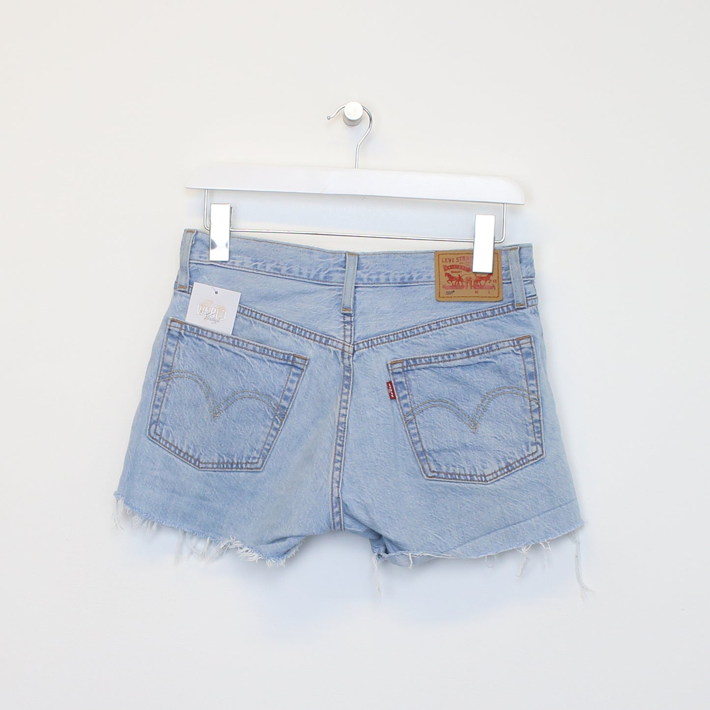 Vintage Women's Levi's denim cut off shorts in blue. Best fits W29