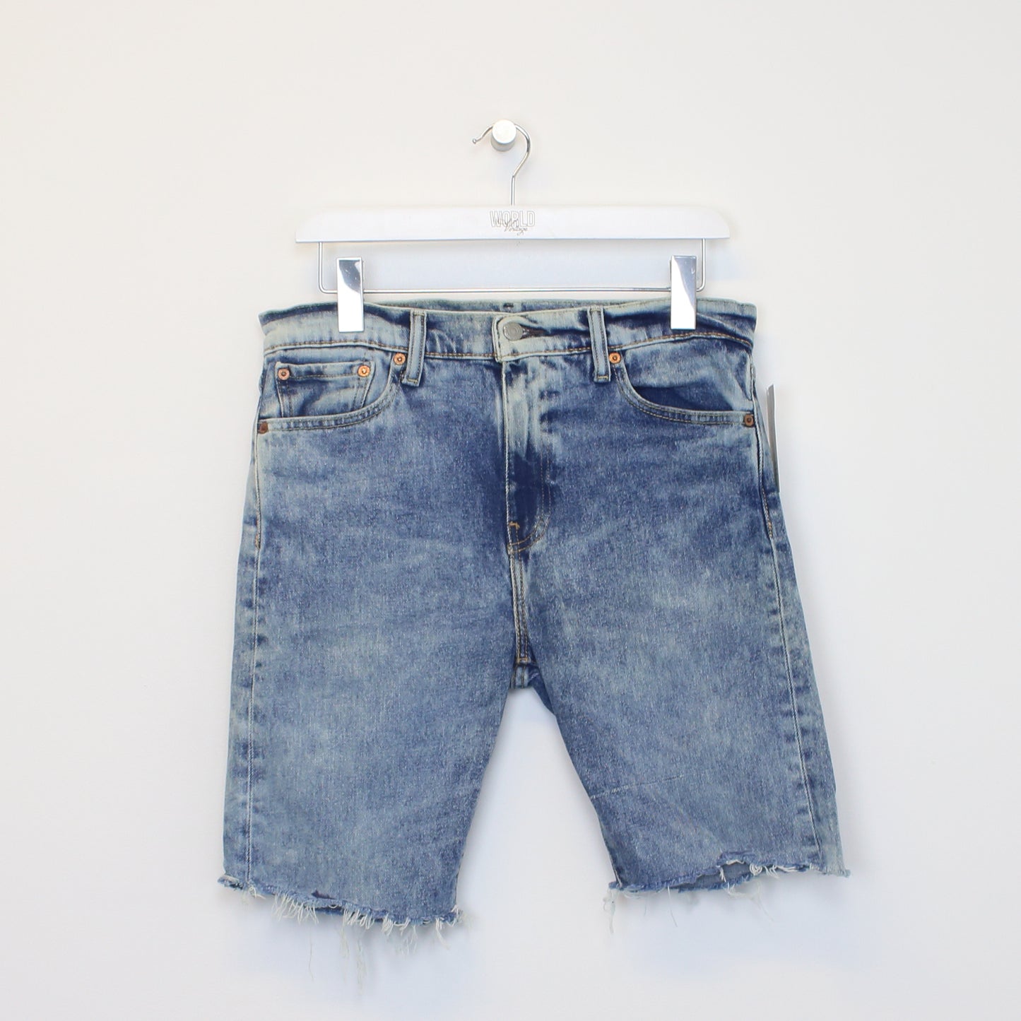 Vintage Levi's denim cut off shorts in blue. Best fits W31