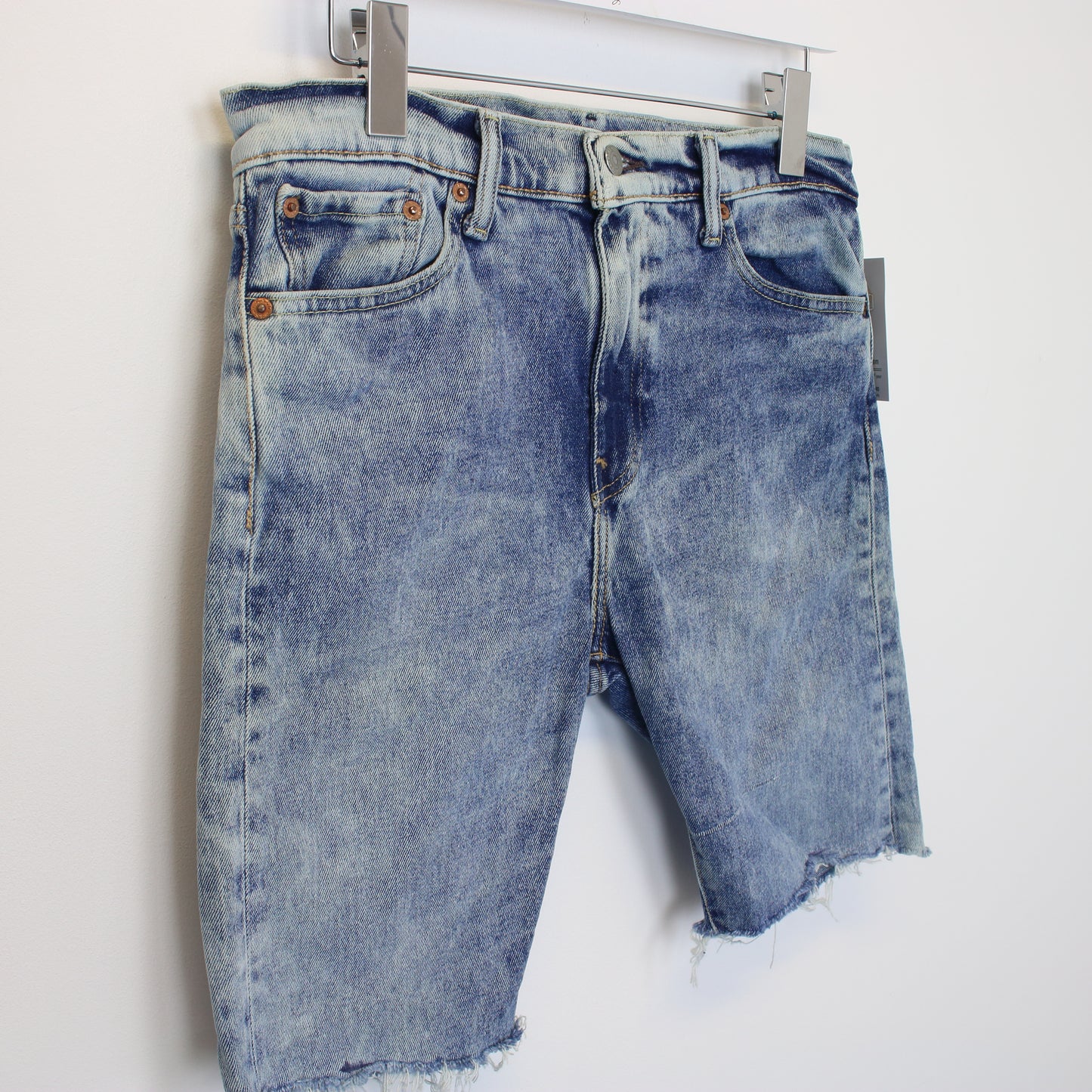 Vintage Levi's denim cut off shorts in blue. Best fits W31