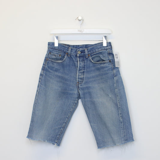 Vintage Levi's denim cut off shorts in blue. Best fits W29