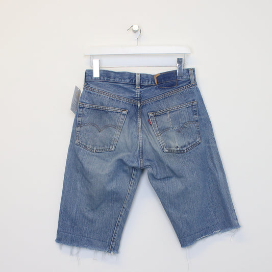 Vintage Levi's denim cut off shorts in blue. Best fits W29