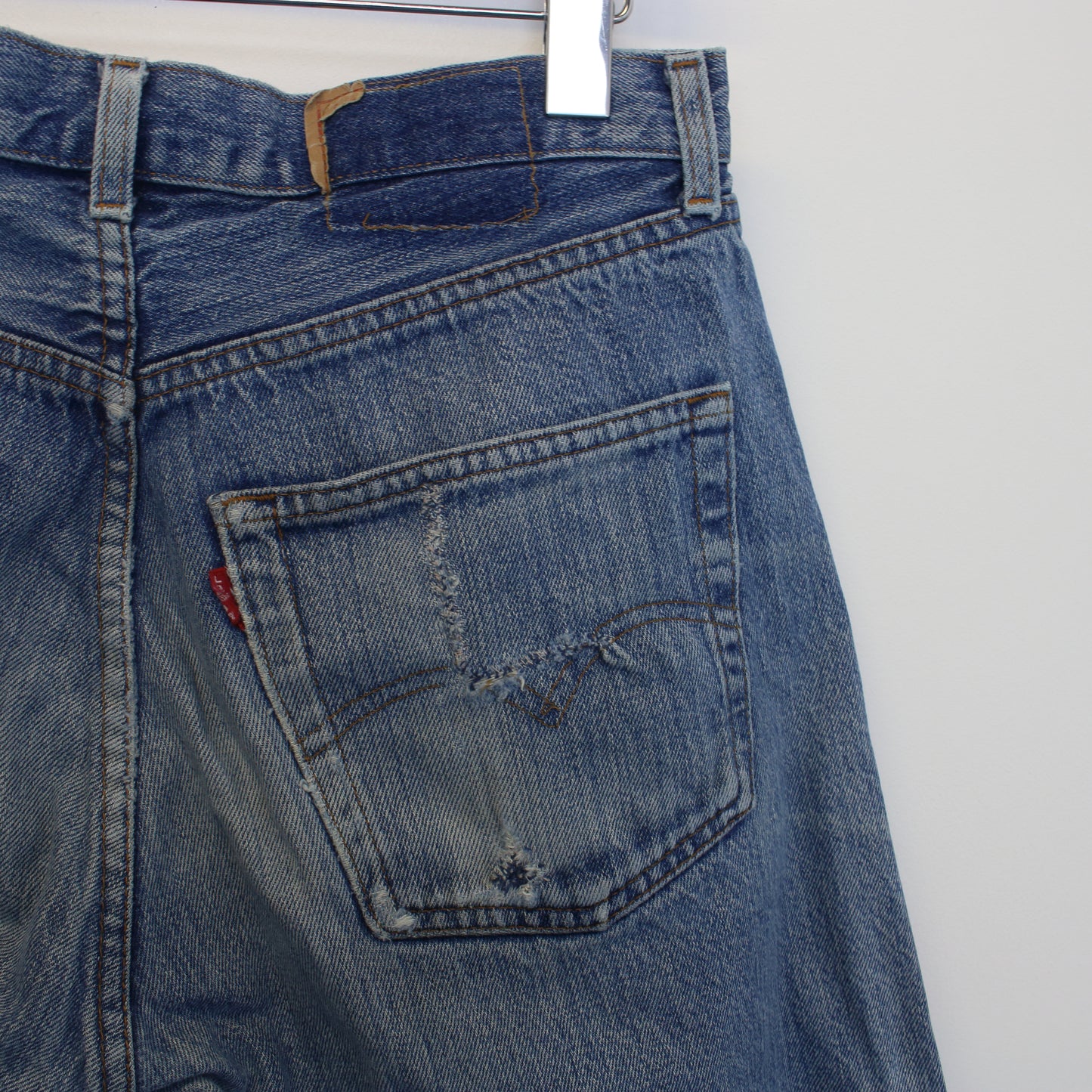 Vintage Levi's denim cut off shorts in blue. Best fits W29