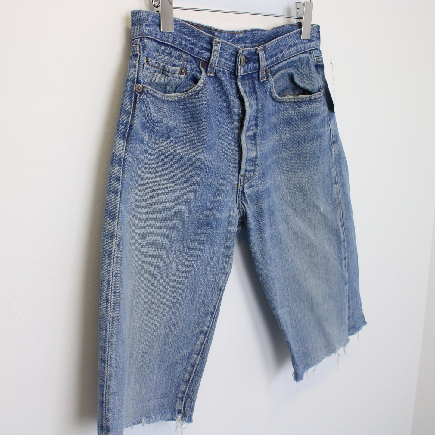 Vintage Levi's denim cut off shorts in blue. Best fits W29