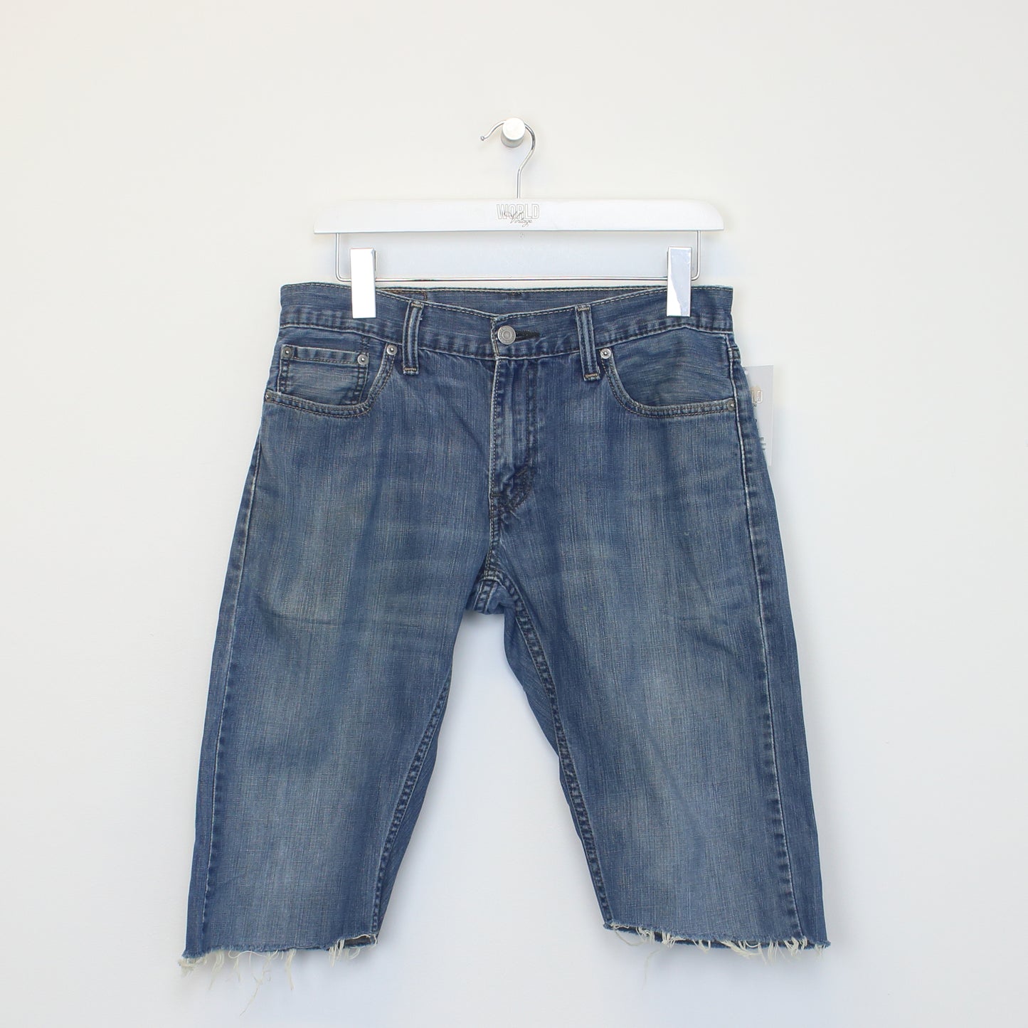 Vintage Levi's denim cut off shorts in blue. Best fits W30