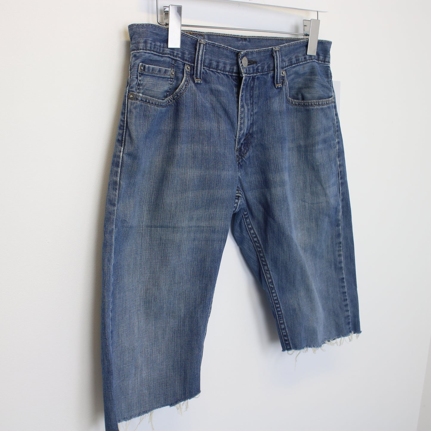 Vintage Levi's denim cut off shorts in blue. Best fits W30