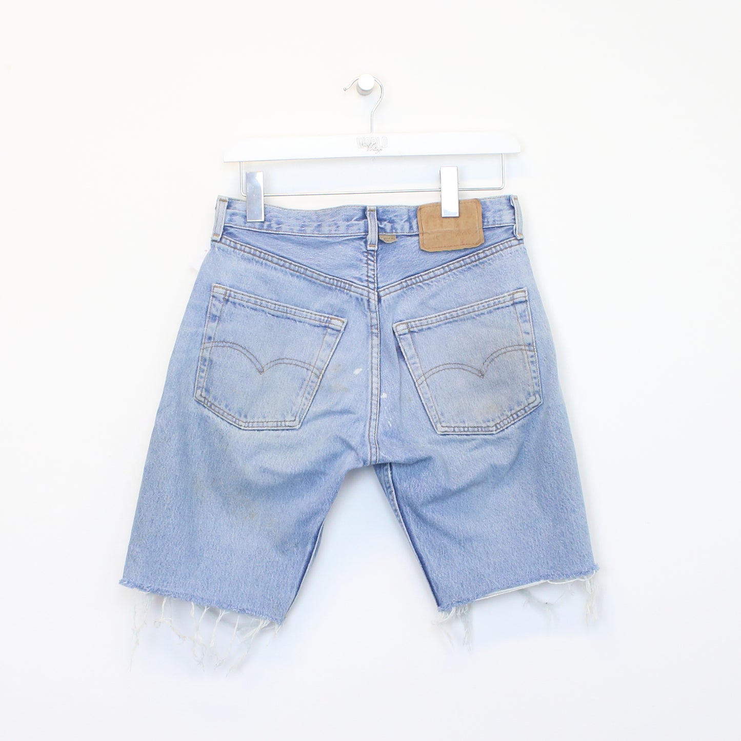 Vintage Levi's denim cut off shorts in blue. Best fits W28