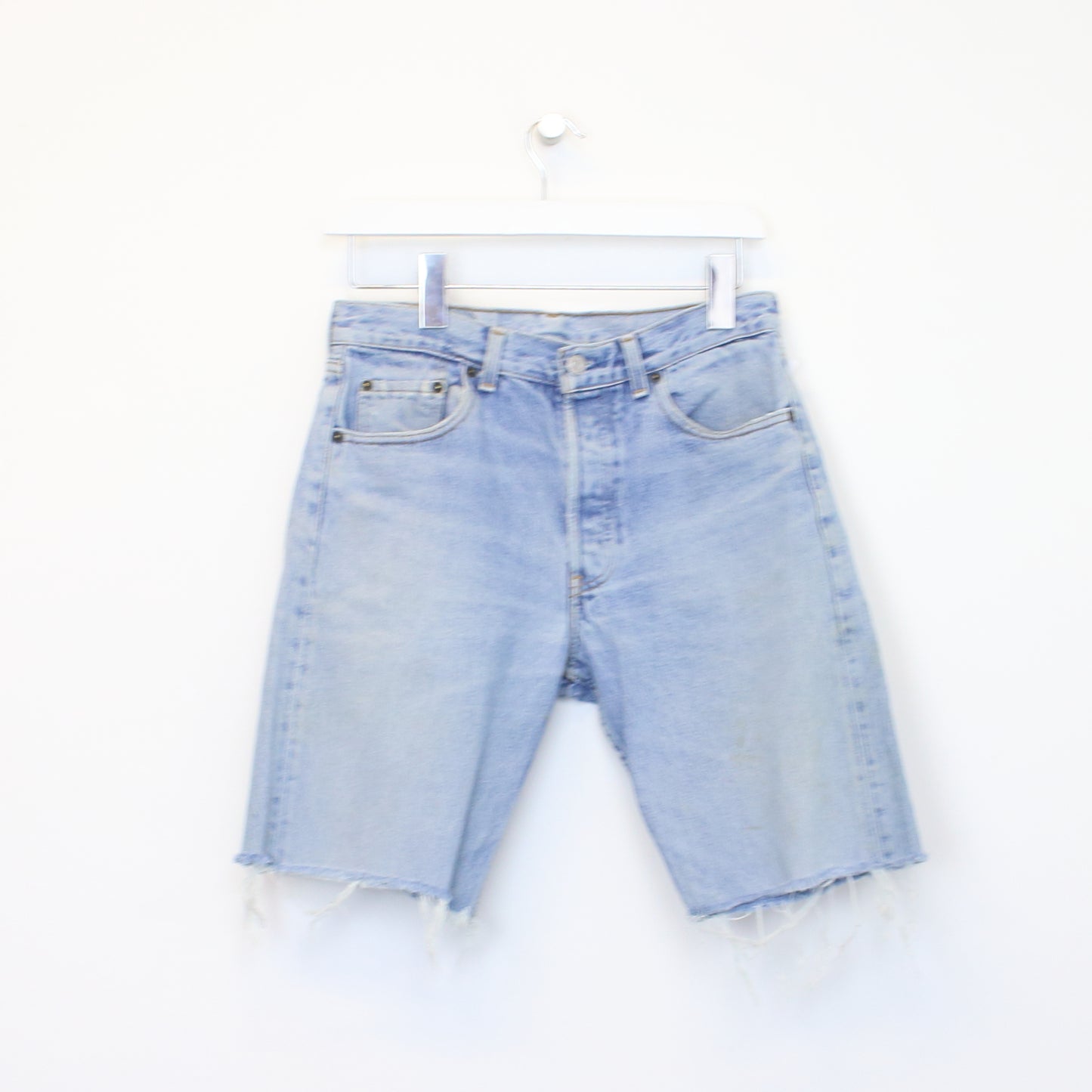 Vintage Levi's denim cut off shorts in blue. Best fits W28