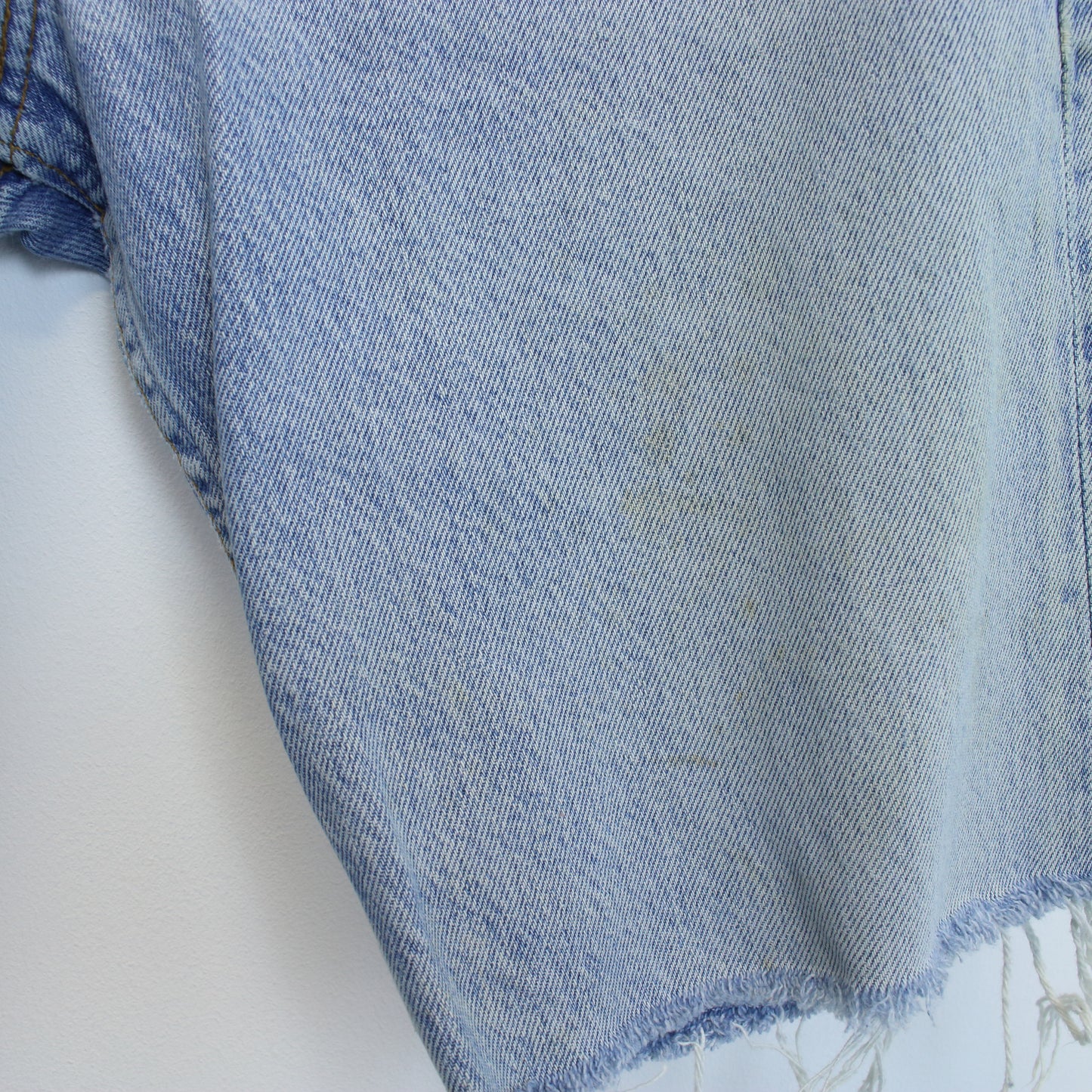 Vintage Levi's denim cut off shorts in blue. Best fits W28