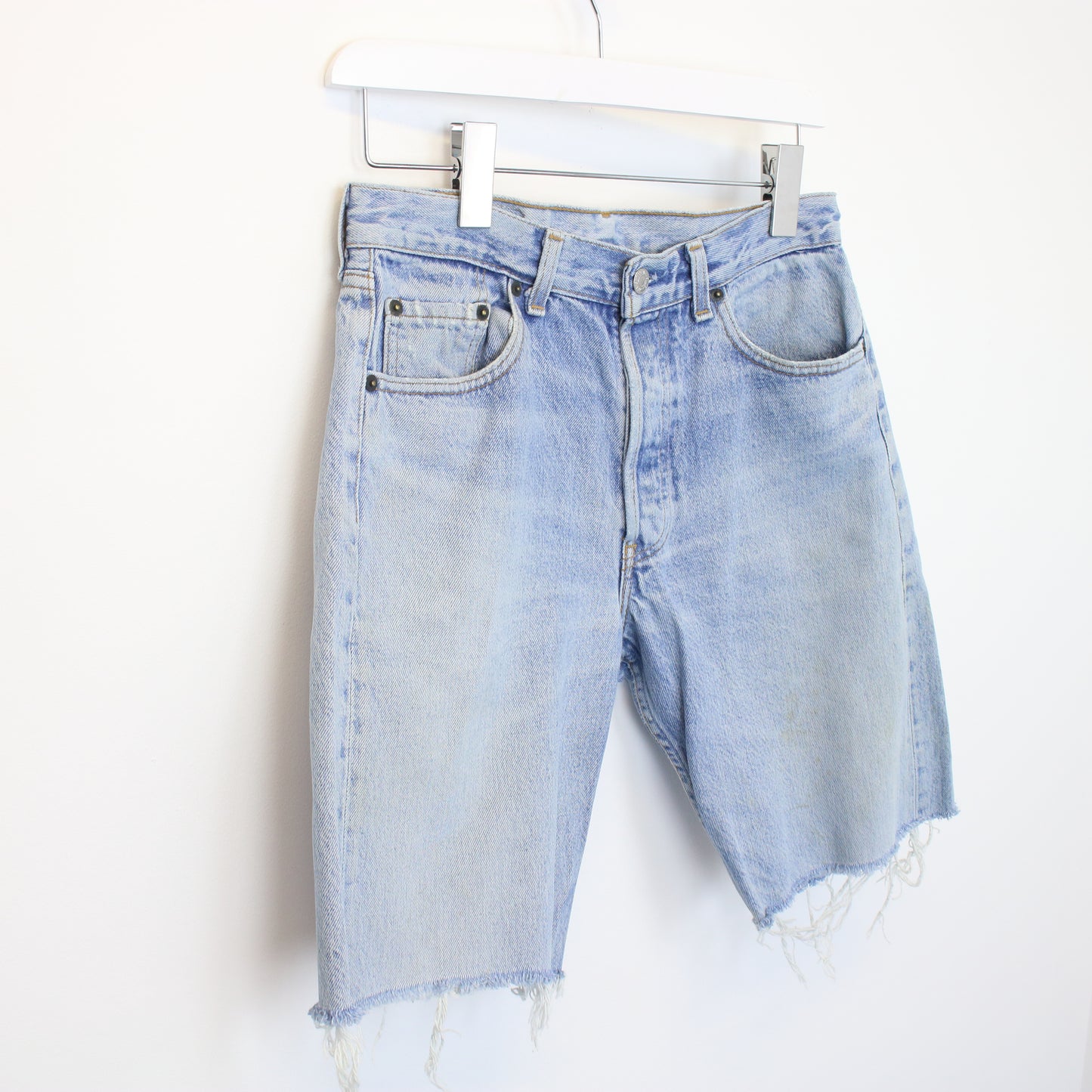 Vintage Levi's denim cut off shorts in blue. Best fits W28