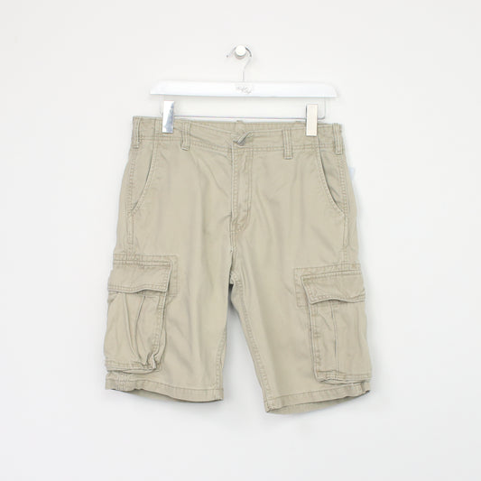 Vintage Levi Cargo shorts in beige. Best fits W32