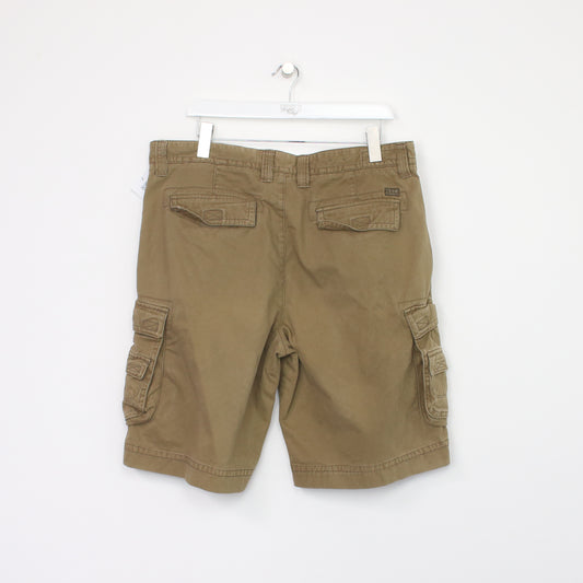 Vintage Izod Cargo shorts in tan. Best fits W38