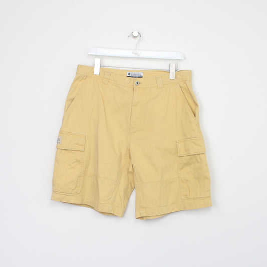 Vintage Columbia Cargo shorts in yellow. Best fits W34