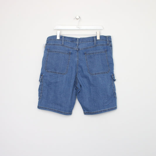 Vintage Wrangler denim cargo shorts in blue. Best fits W38