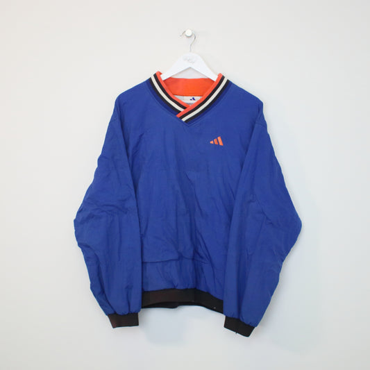 Vintage Adidas windbreaker sweatshirt in blue with orange details. Best fits M