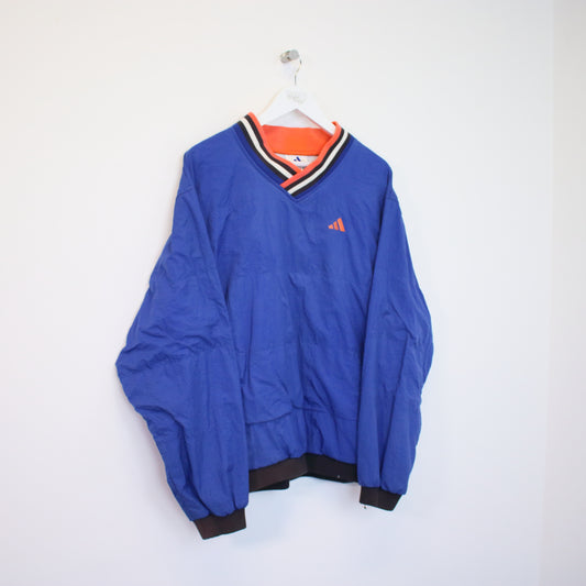 Vintage Adidas windbreaker sweatshirt in blue with orange details. Best fits M