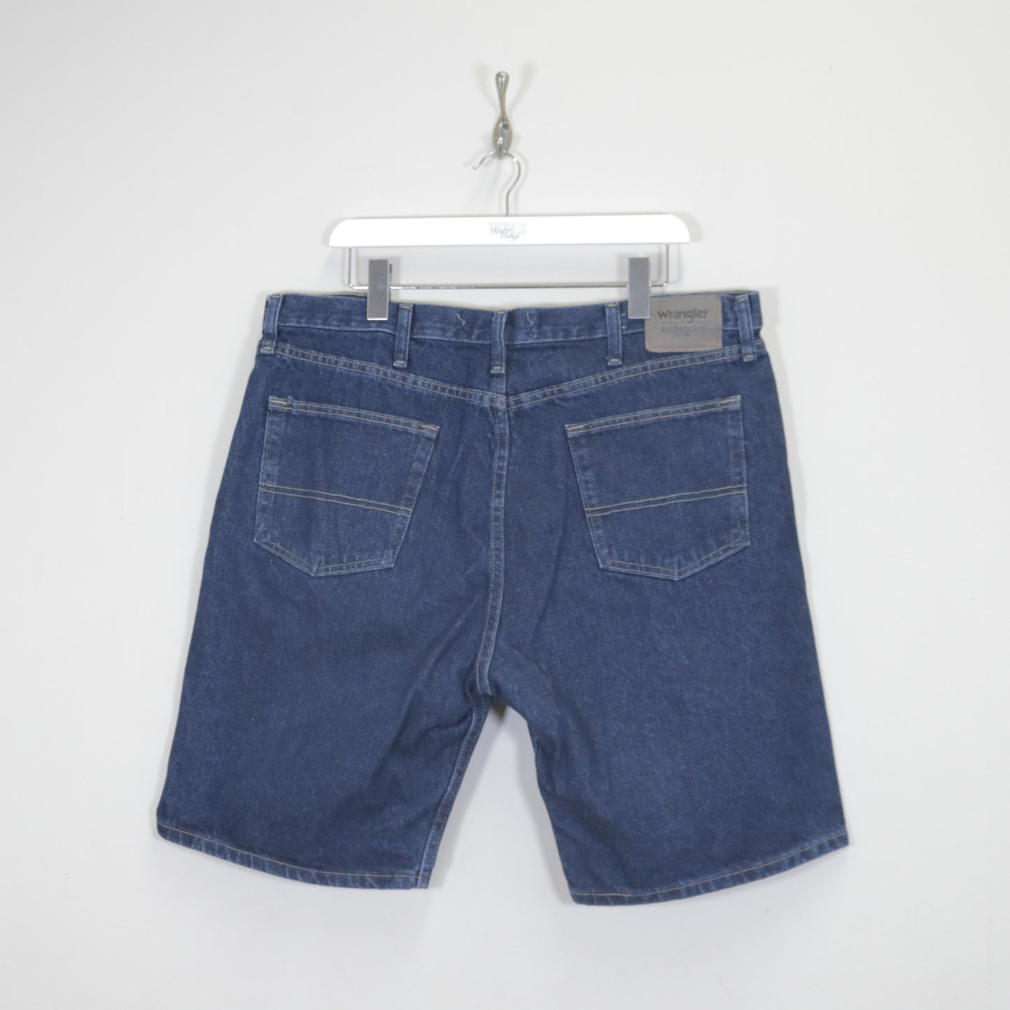 Vintage Wrangler denim cargo shorts in blue. Best fits W38