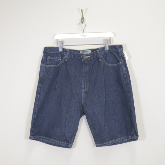 Vintage Wrangler denim cargo shorts in blue. Best fits W38