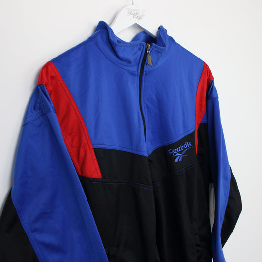 Vintage Reebok track jacket in blue, black and red. Best fits S