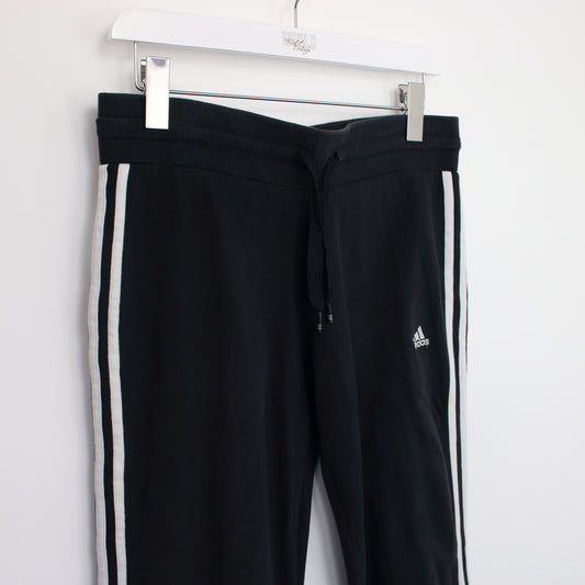 Vintage Adidas joggers in black. Best fits S